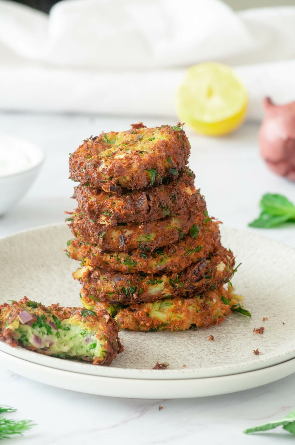 Stack zucchini fritters on a plate.