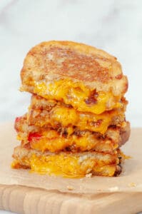 Grilled cheese with three cheeses stacked on top of each other.