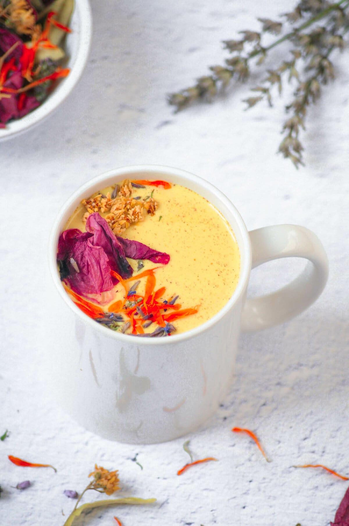 Moon Milk in a cup with lots of pretty edible flowers.