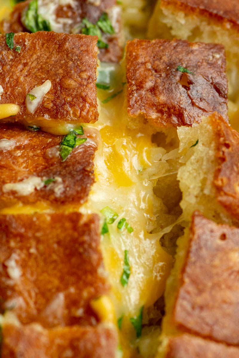 Zoom on melty cheese inside crack bread.