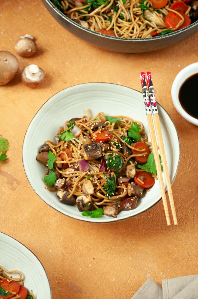 Yakiudon dans un bol avec des baguettes.