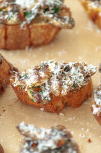 Garlic crostini topped with grilled mushrooms and grated Parmesan.