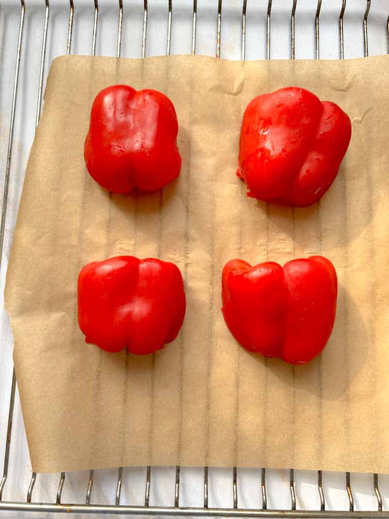 Half peppers on a baking sheet.