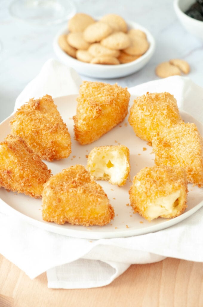 Focus on breaded camembert on a plate.