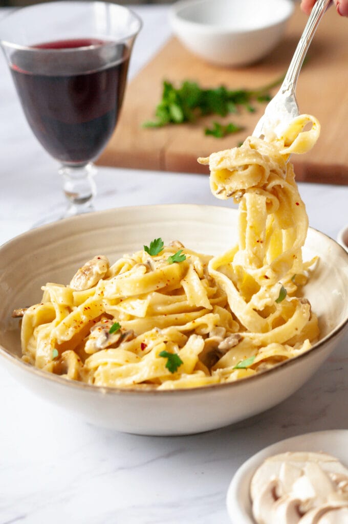 Fork turning pasta with gorgonzola cream.