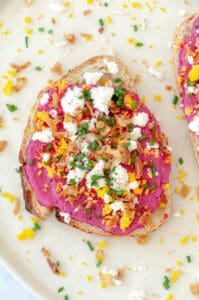 Toast with beet cream on a plate.