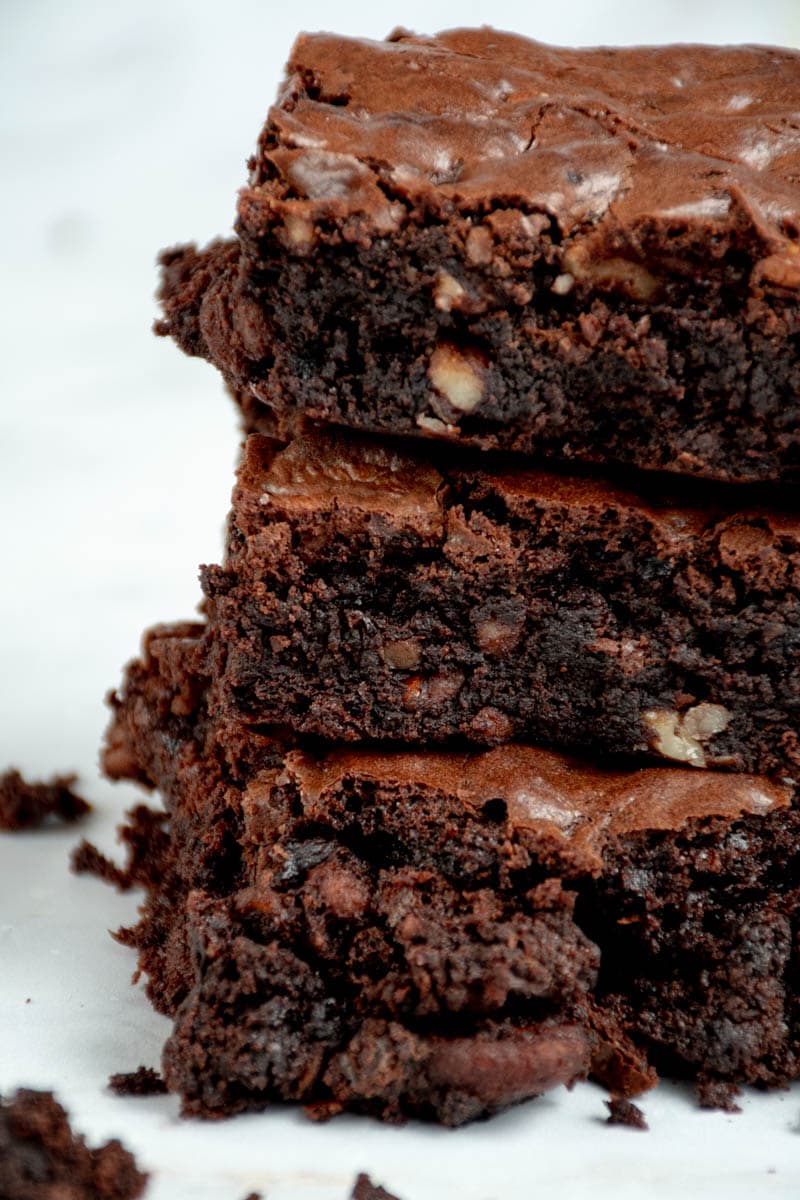 Pieces of walnut brownie stacked on top of each other.