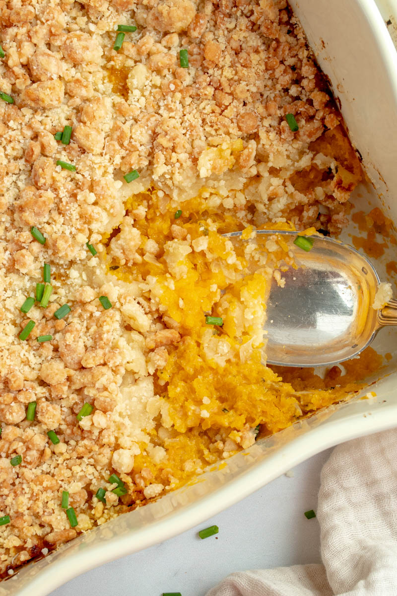 Large spoon that takes a slice of butternut crumble.