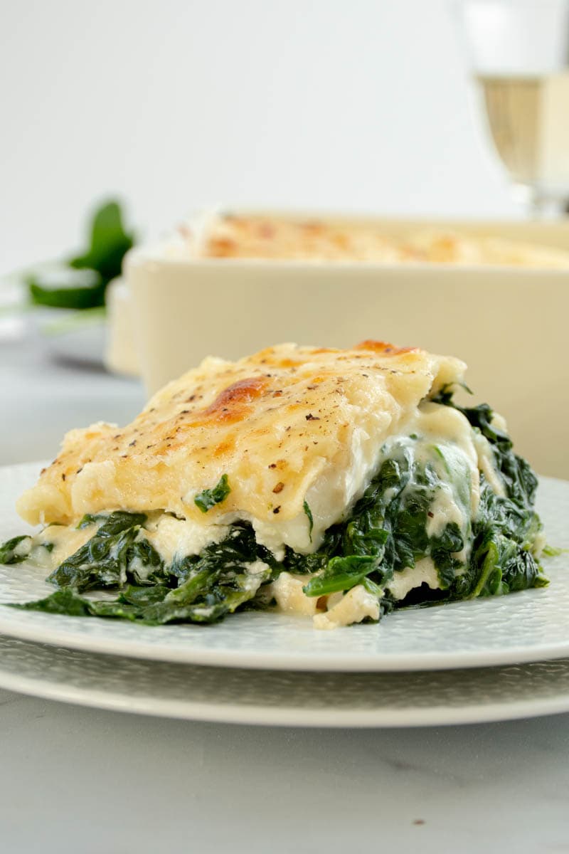 Slice of spinach and goat's cheese lasagne on a plate.