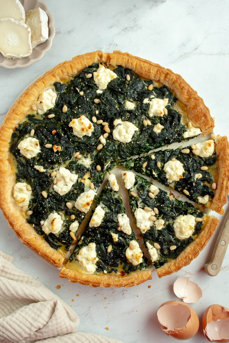Spinach tart with three slices.