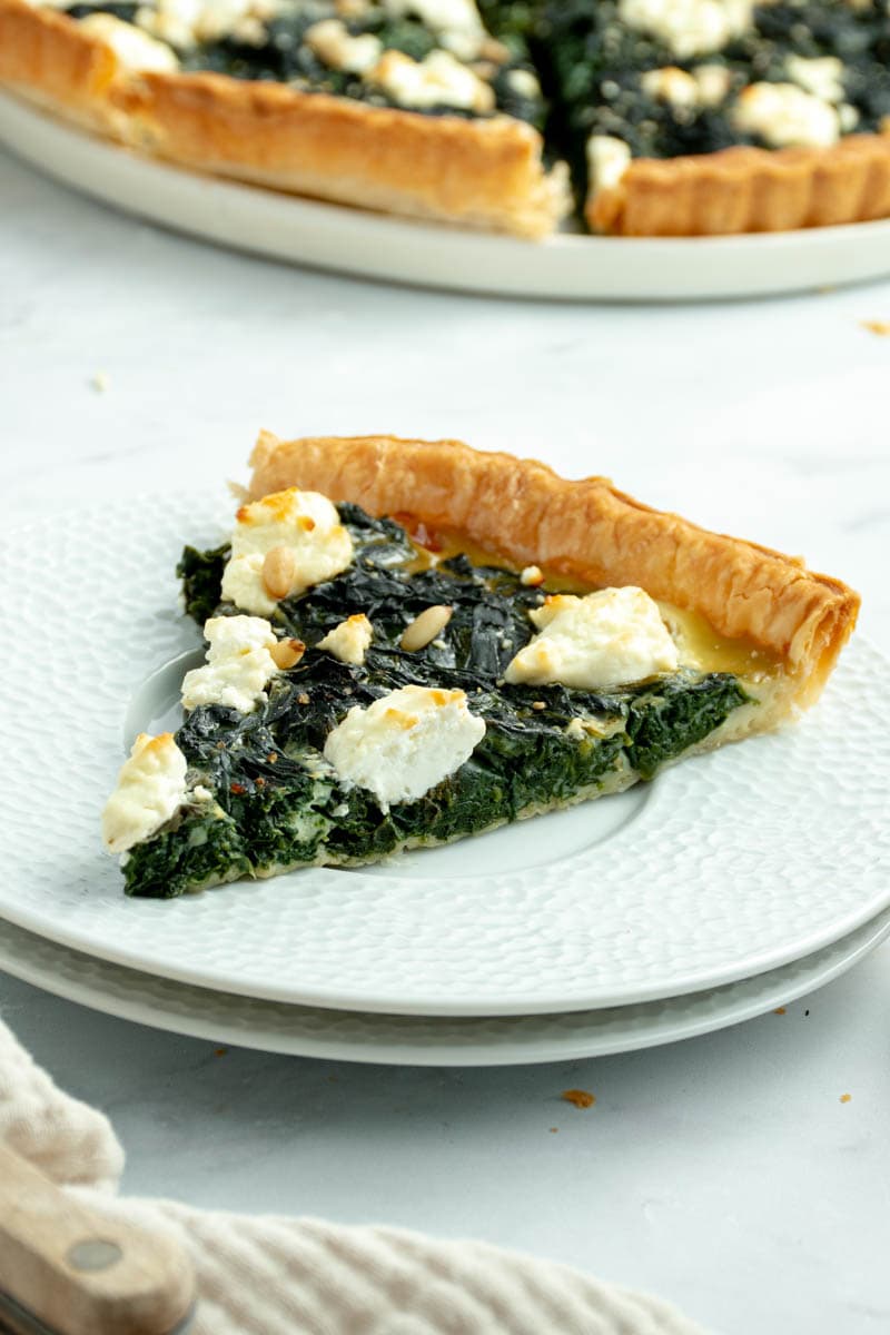Slice of spinach pie on a plate.