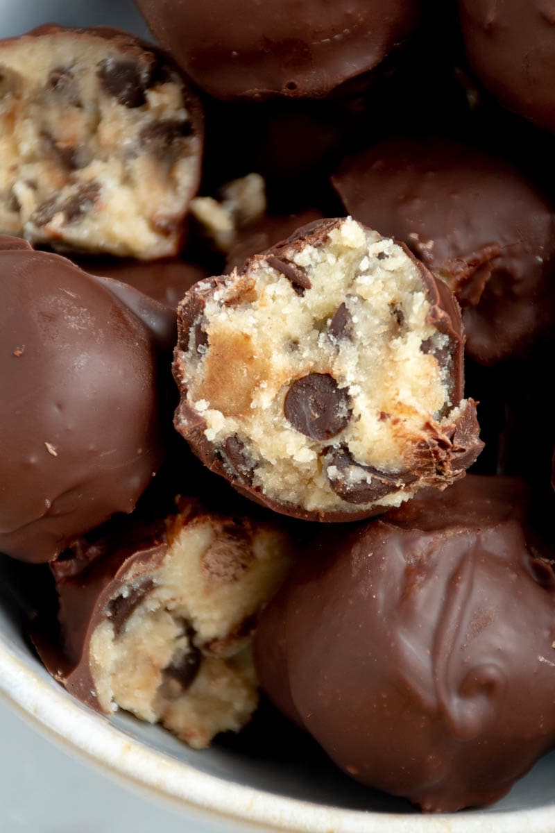 Several cookie dough truffles in a bowl.