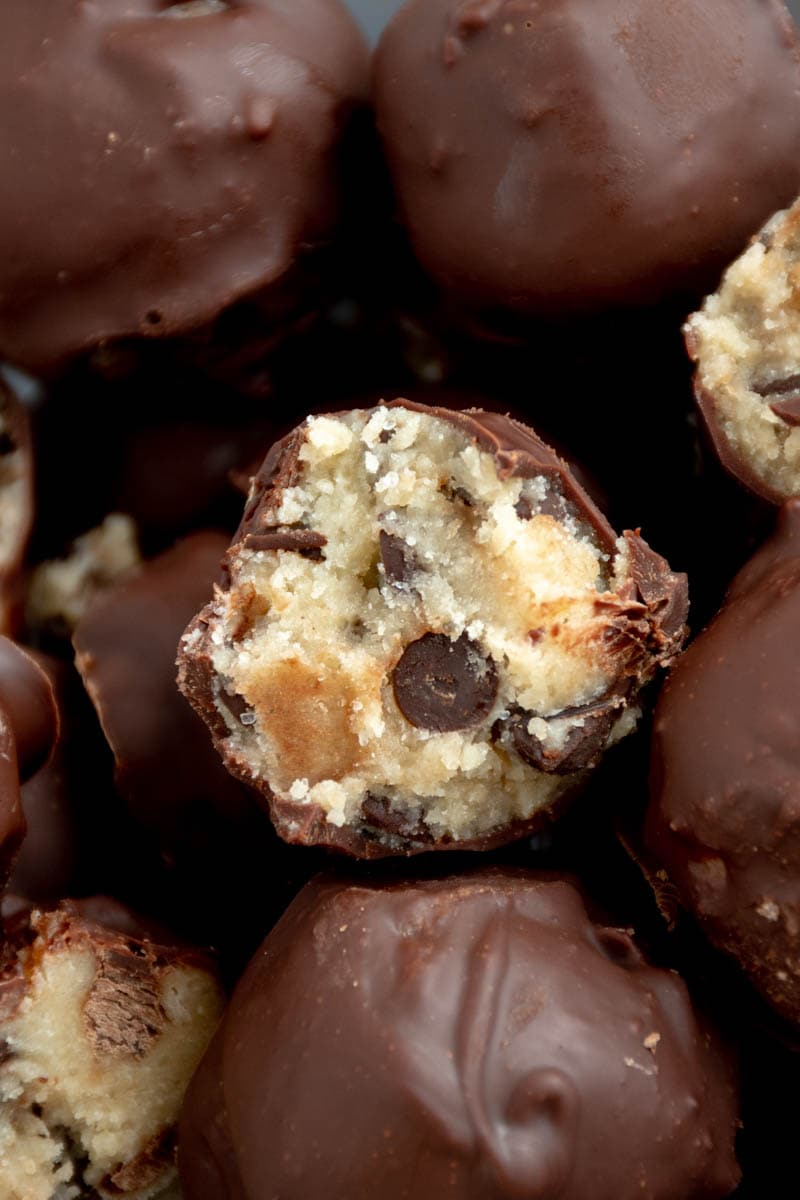 Several cookie dough truffles in a bowl.