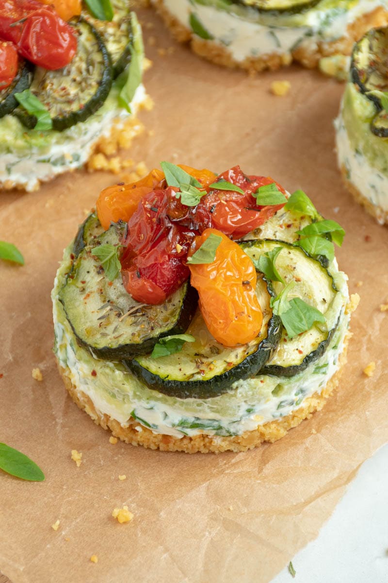 Savoury cheesecake with fromage frais, avocado and roasted summer vegetables on baking paper.
