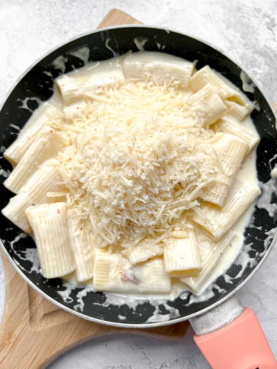 Add the Parmesan cheese to the pan of pasta and sauce.