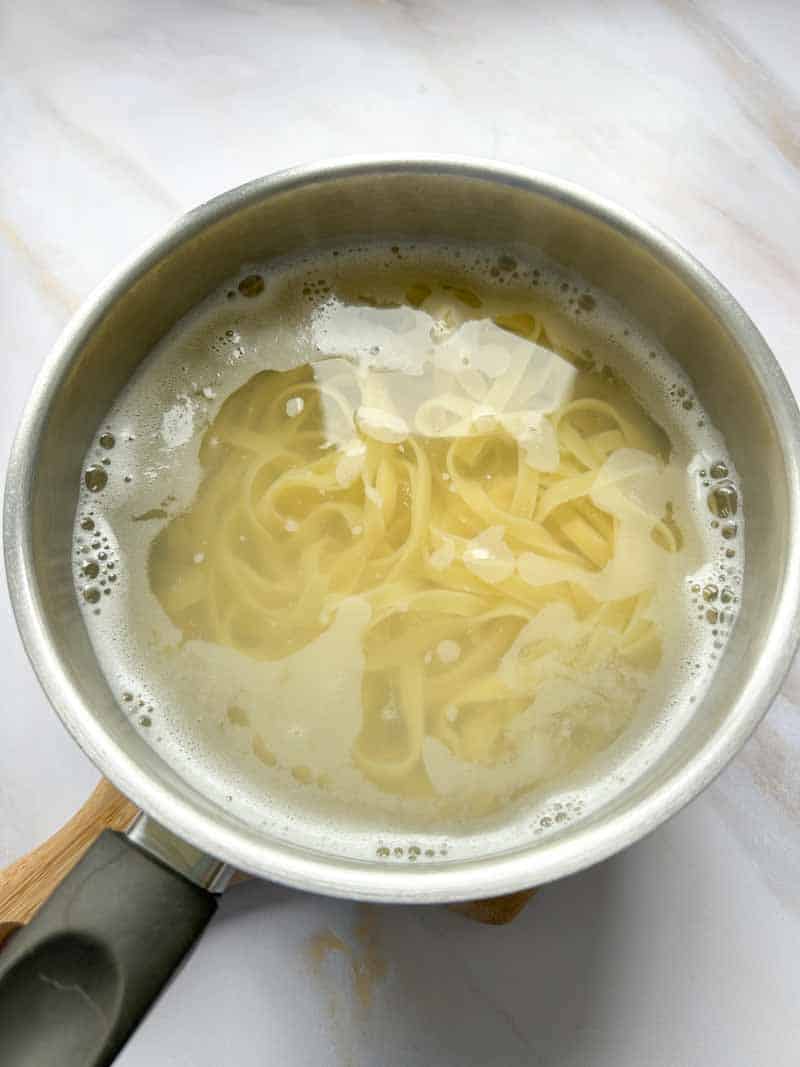 Pasta in a pan of water.