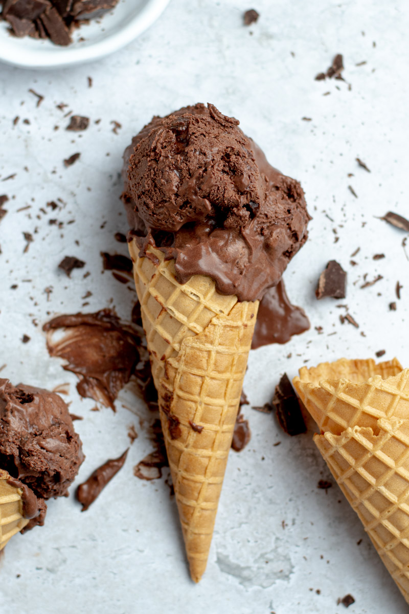 Scoops of chocolate ice cream in a cone.