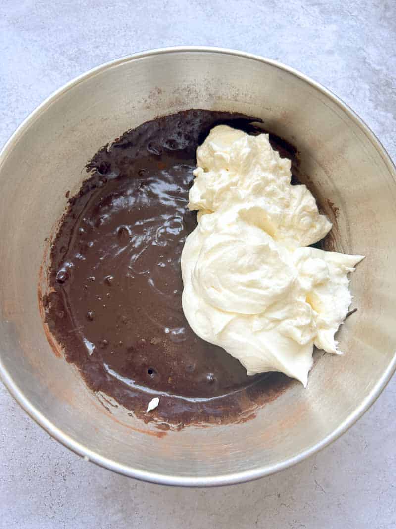 Spoon the whipped cream into the bowl of chocolate.
