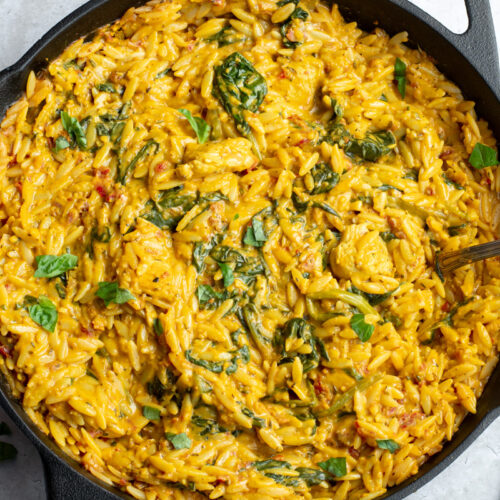 Cajun chicken Orzo in a black cast-iron skillet.