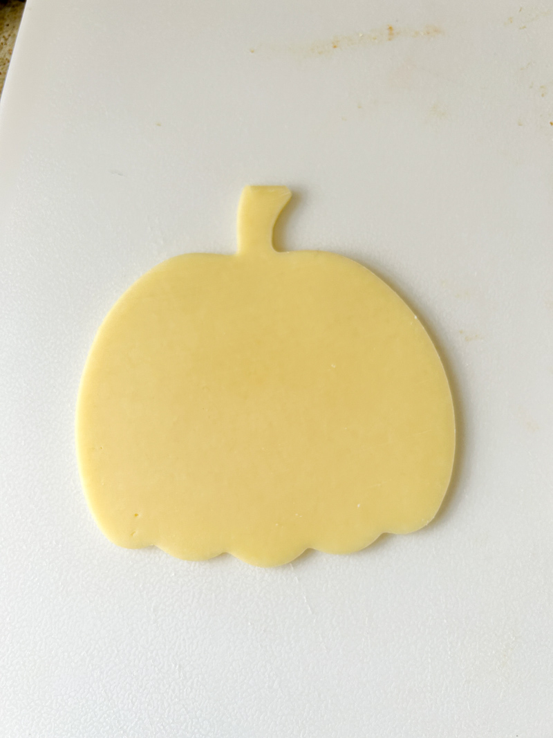 Slice of gouda cheese in a form of pumpkin.