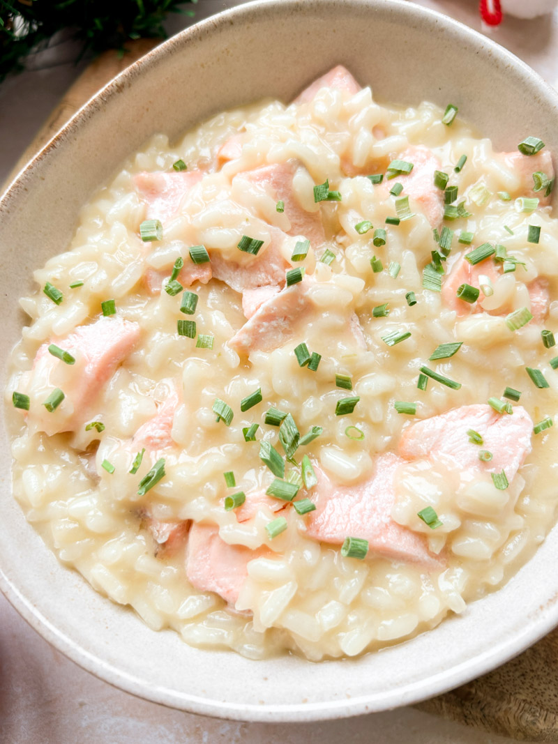 Fresh chopped chives added to the bowl of cooked salmon risotto.