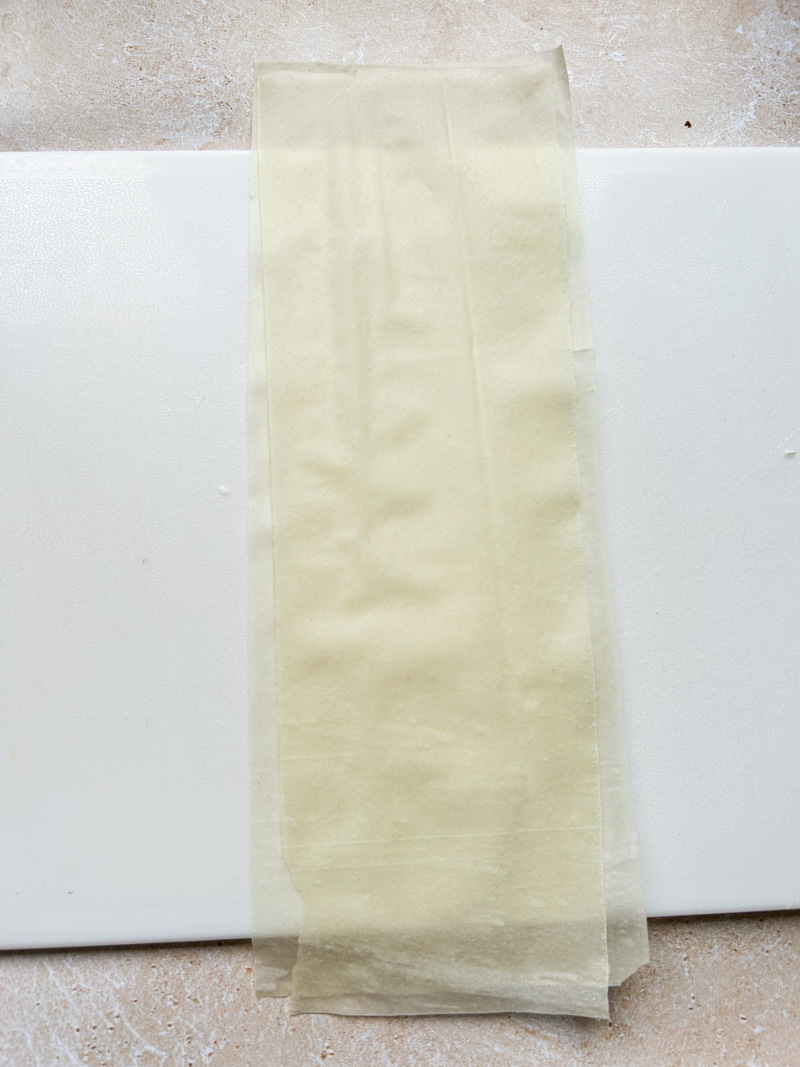 Two strips of fillo pastry sheet on top of each other.