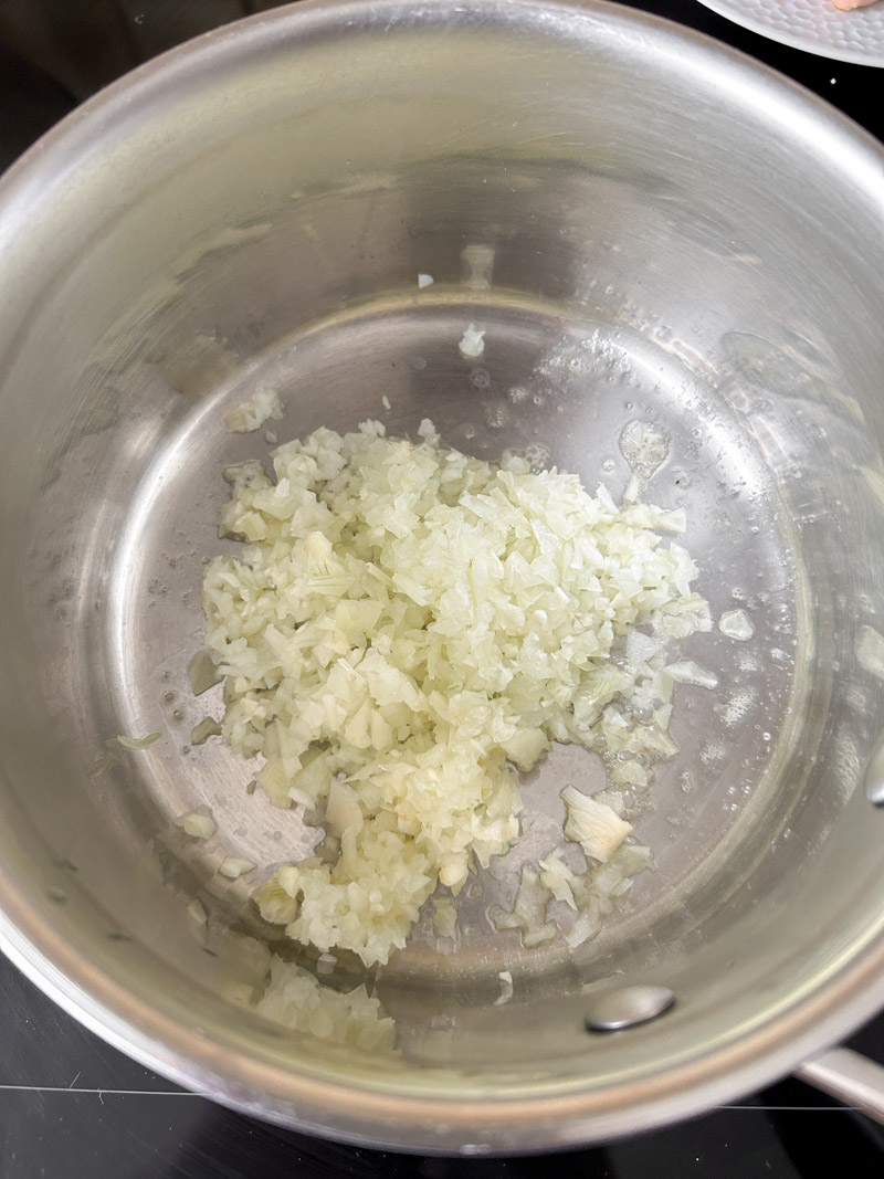 Minced garlic and onion cooking in the saucepan.