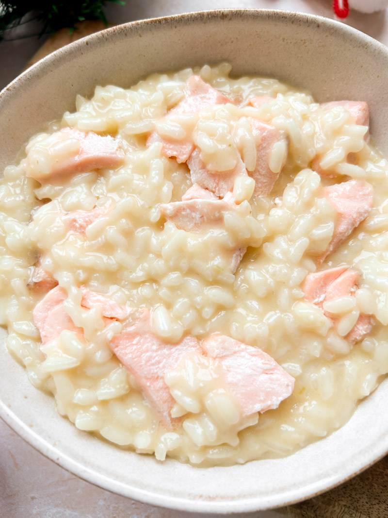Salmon cubes added to the bowl of cooked risotto.
