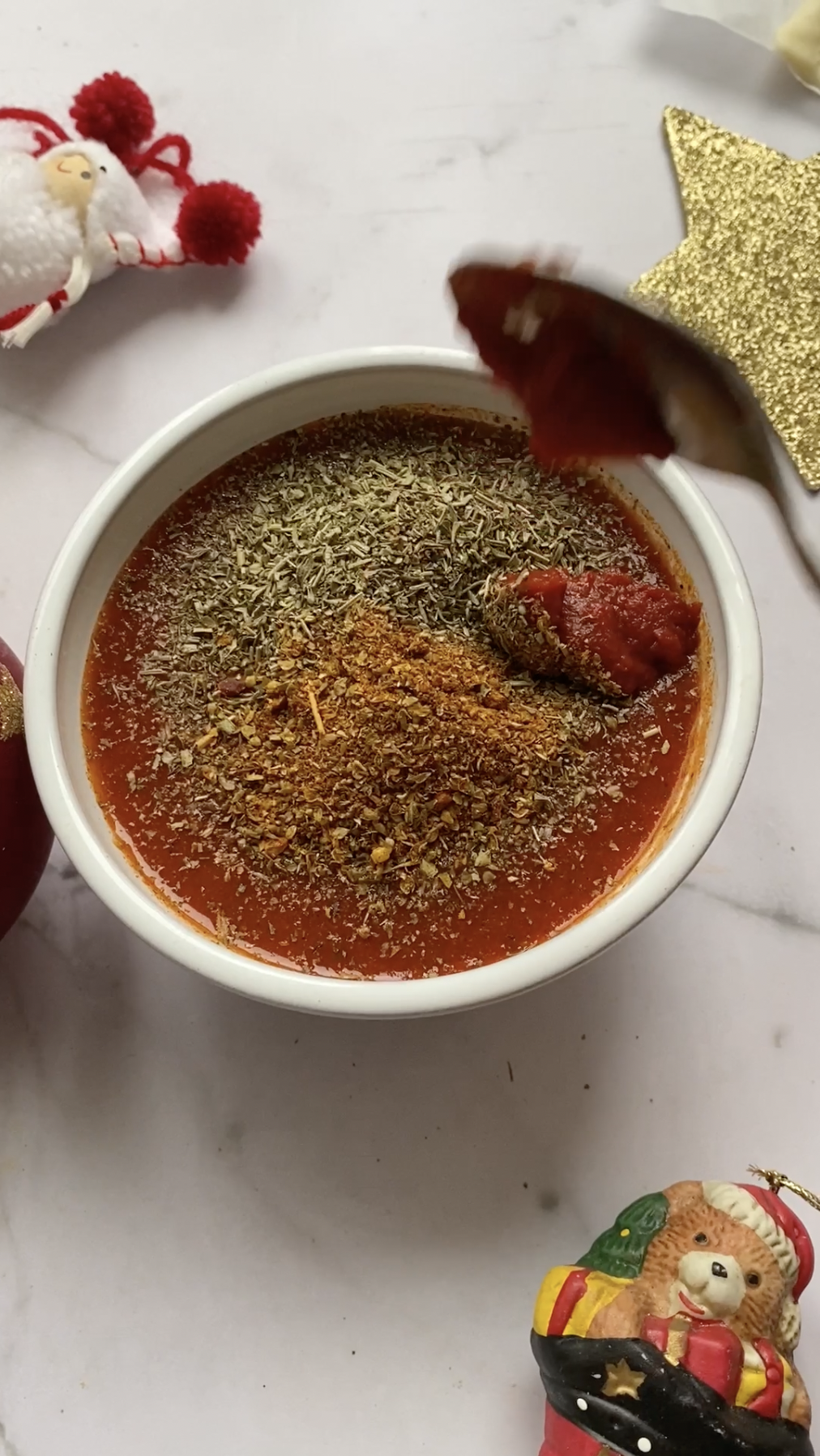 Tomato paste added to the bowl of tomato sauce.