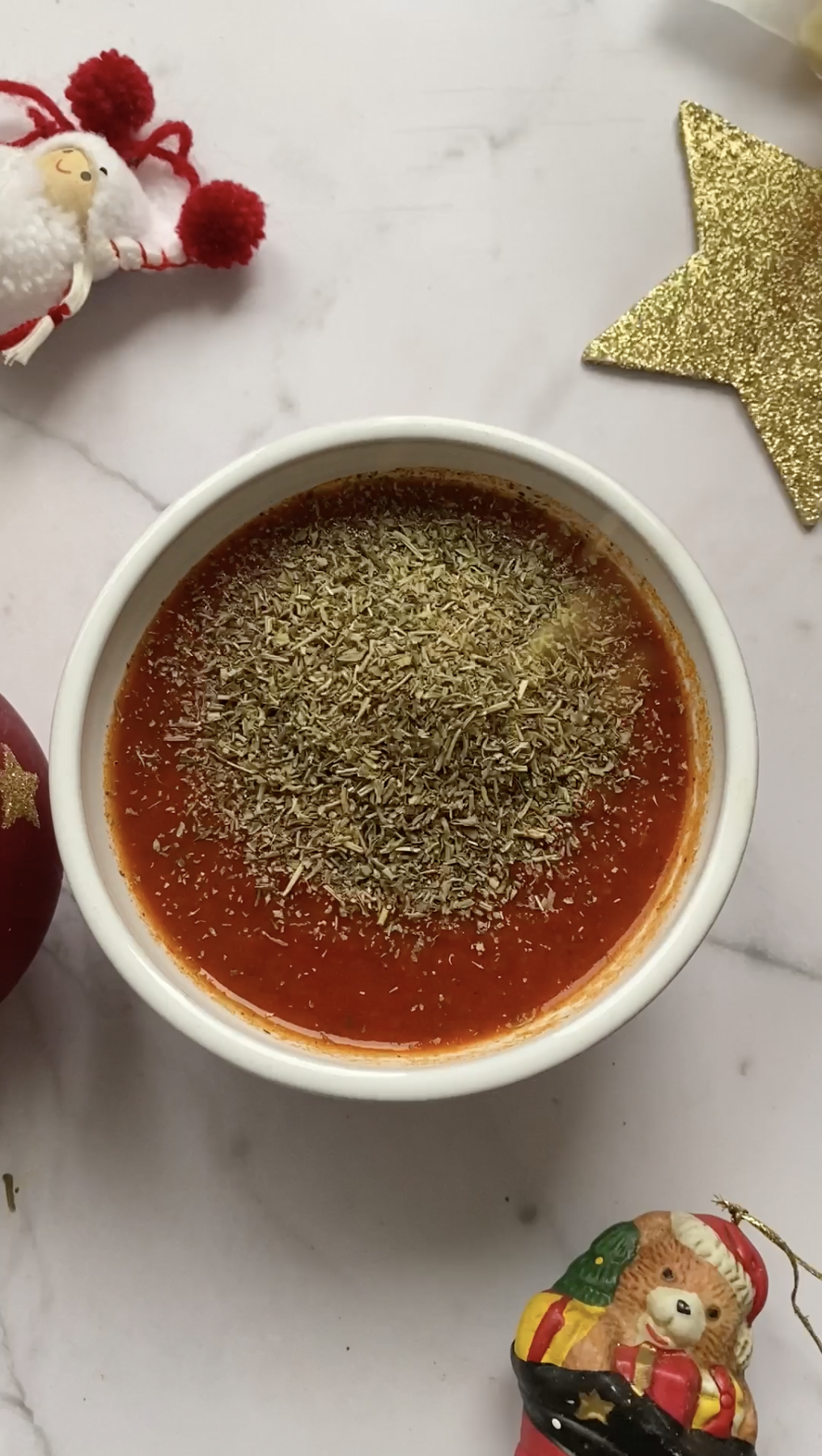 Tomato sauce in a white bowl with herbes de Provence.