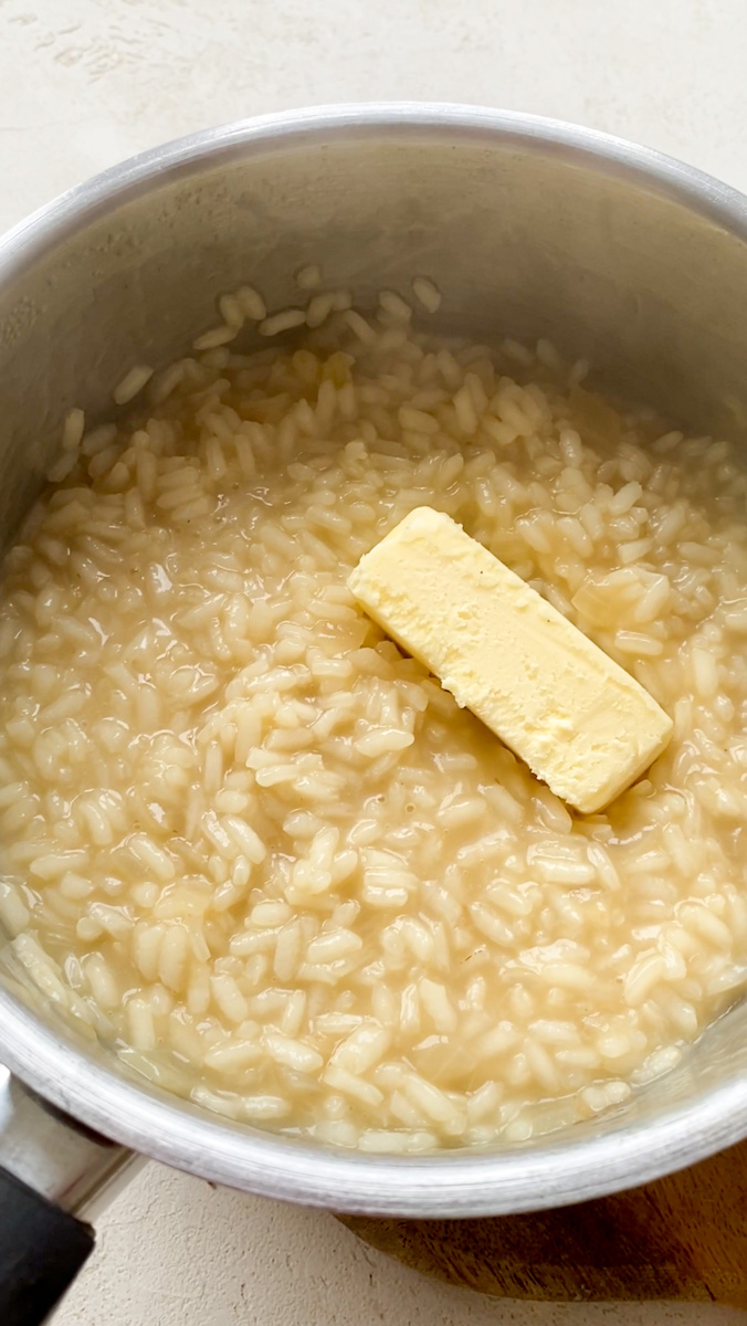 Refrigerated butter added to the saucepan of risotto.