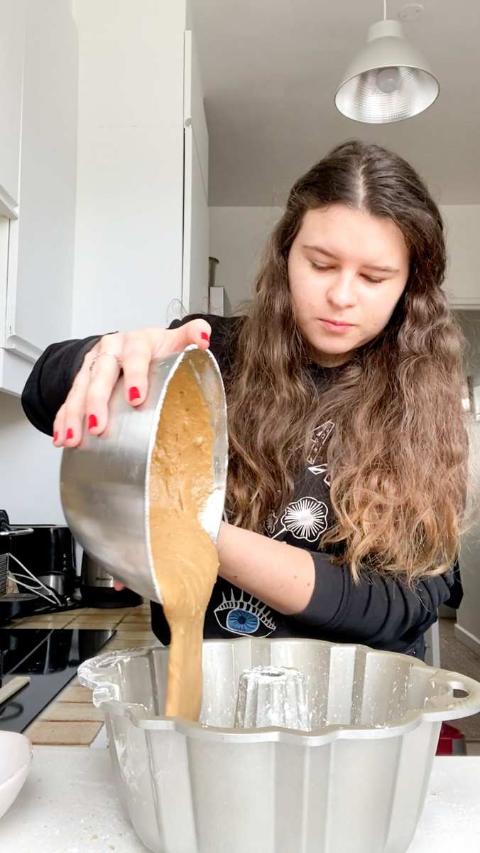 Marie pouring the cake batter in the bundt pan.