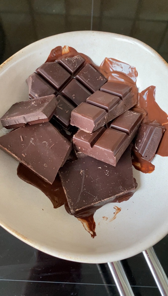 Chocolate bars melting in a beige bowl (double broiler).