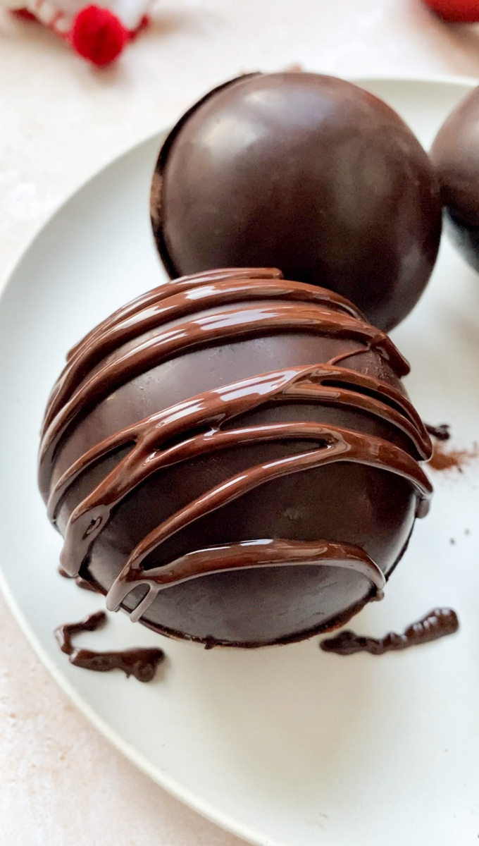Melted chocolate drizzled on a sphere.