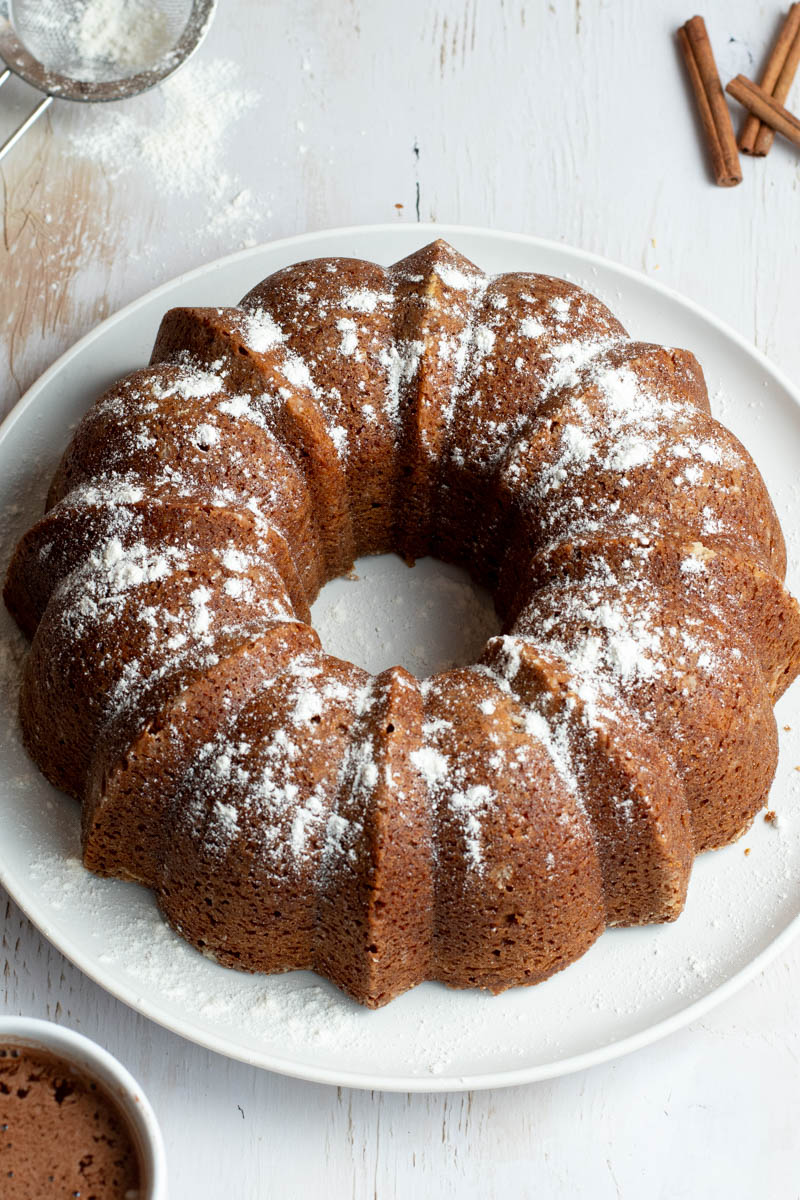 Gingerbread bundt cake on a white plate.