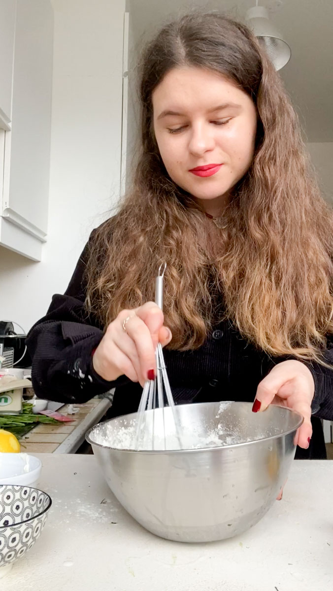 Marie mixing all the ingredients with a manual whisk.