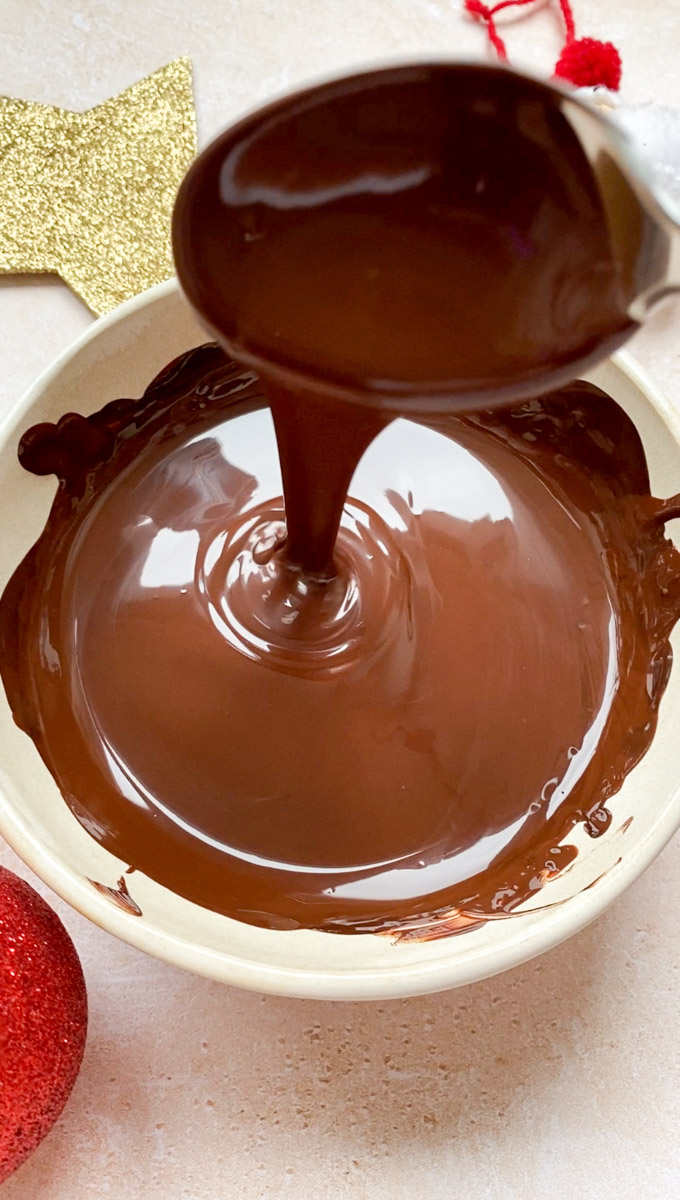 Melted chocolate in a beige bowl.