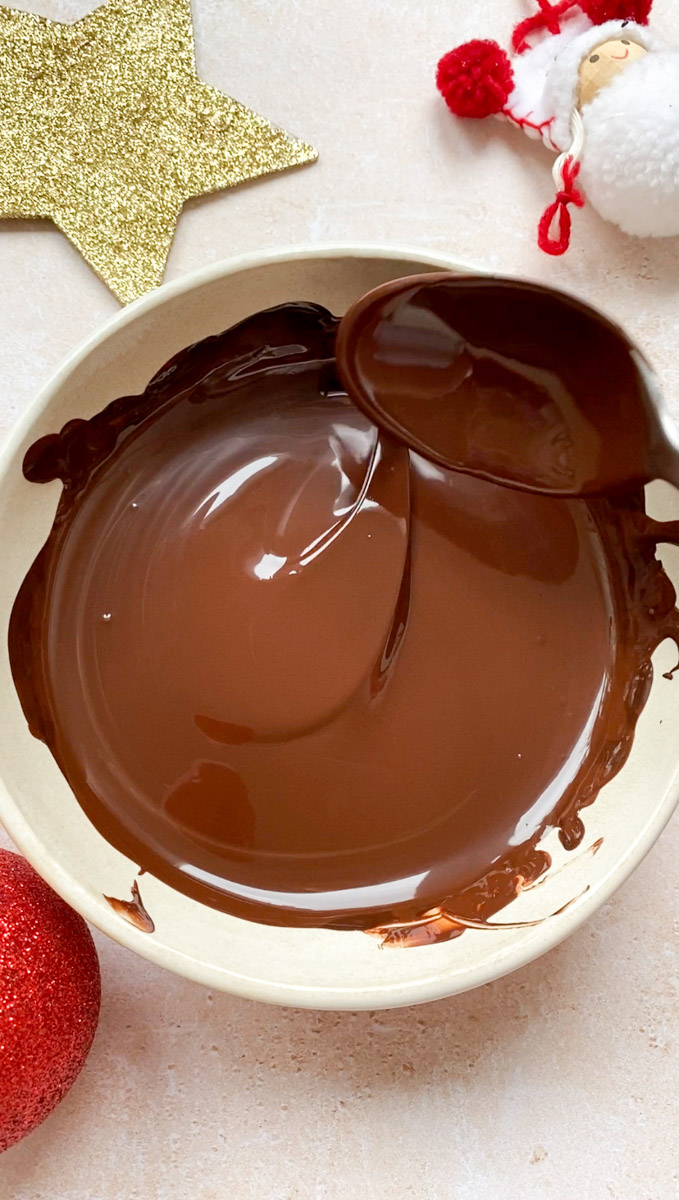Melted chocolate in a beige bowl.