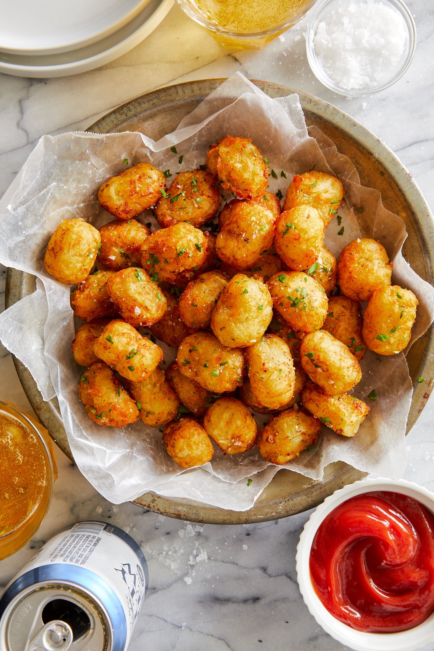 Tater tots in a bowl lined with parchment paper.