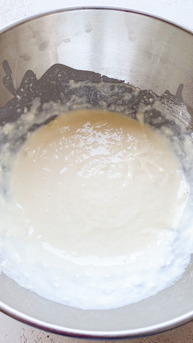 Flour and milk mixed in a grey bowl.