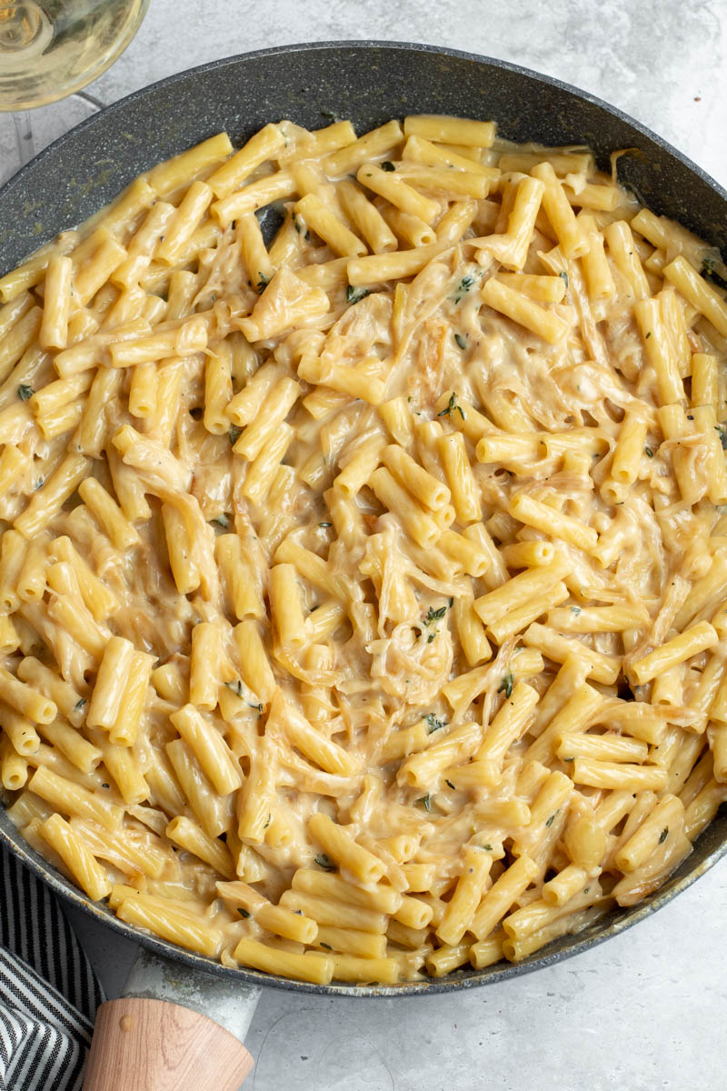 Creamy French onion pasta in a large pan.