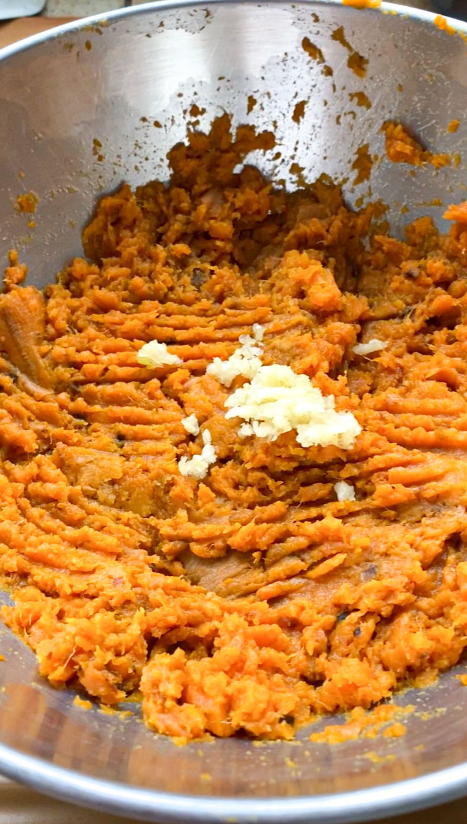 Pressed garlic added to the cooked and crushed sweet potatoes.