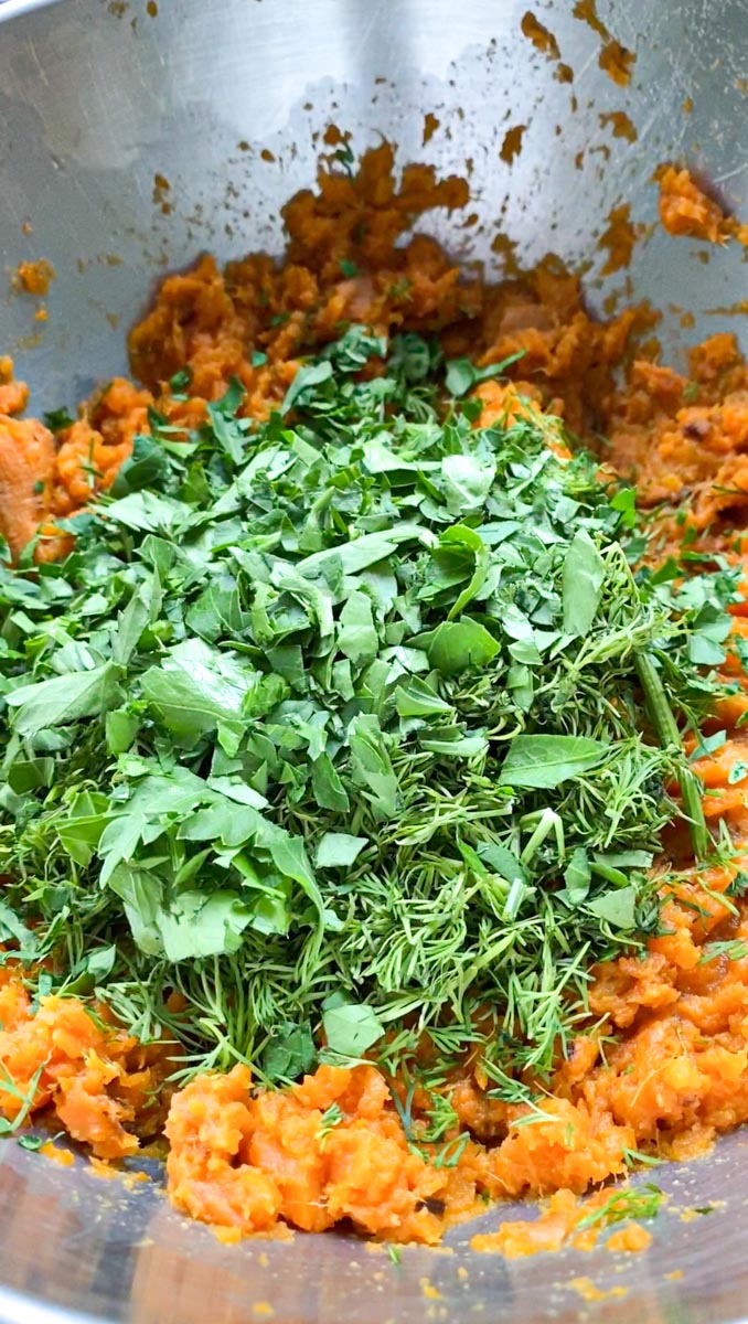 Fresh chopped dill and parsley added to the cooked and crushed sweet potatoes.