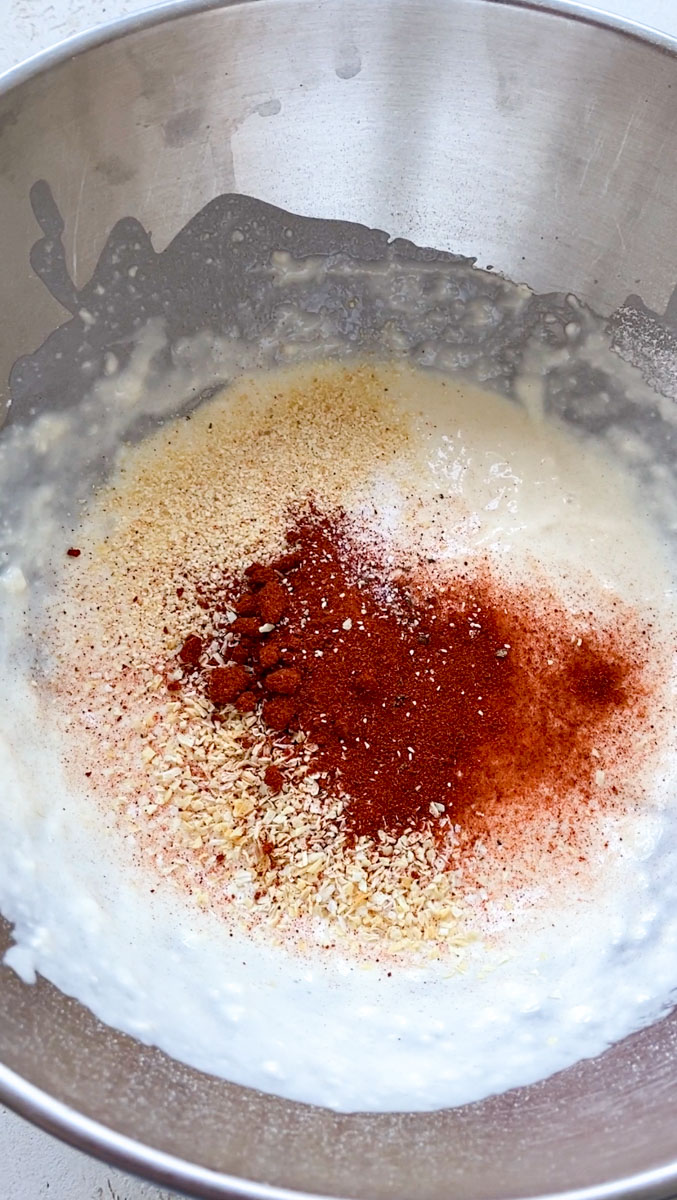 Spices added to the flour and milk batter, in the grey bowl.
