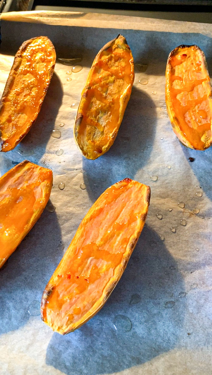 Halves of sweet potato coming out from the oven, cooked.