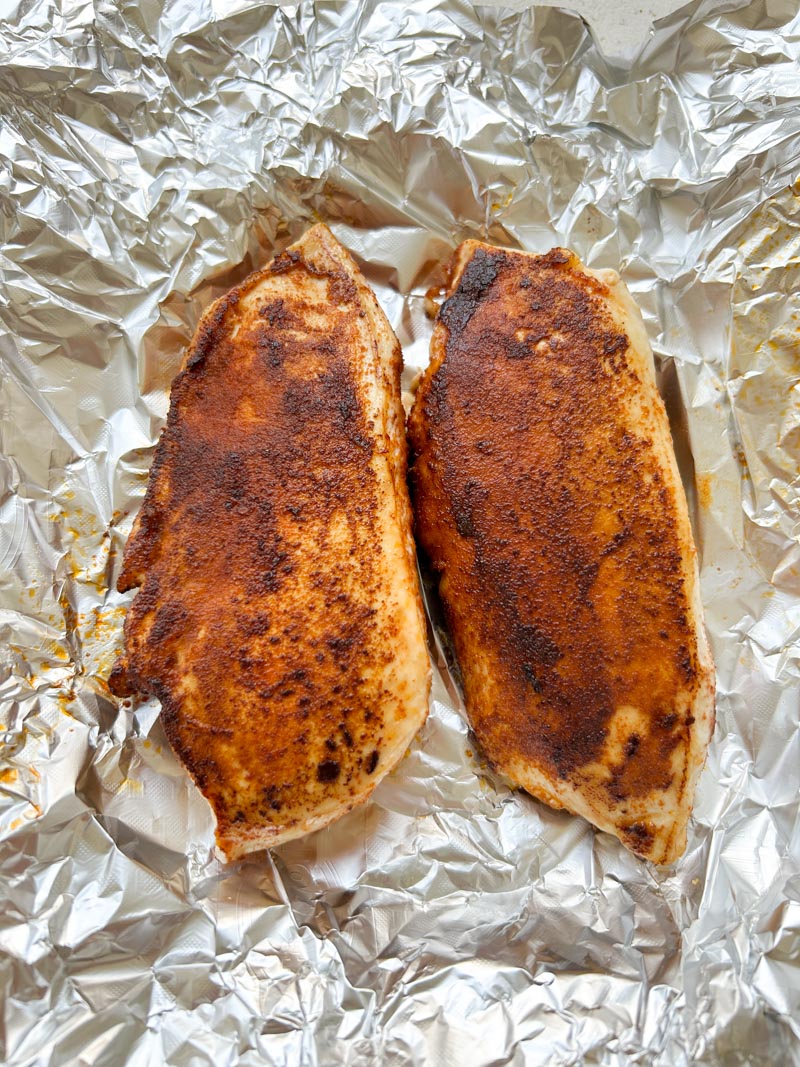Cooked chicken breasts in an aluminium foil.
