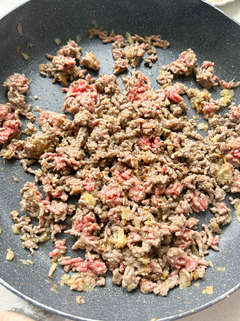 Cooked ground beef in a frying pan.