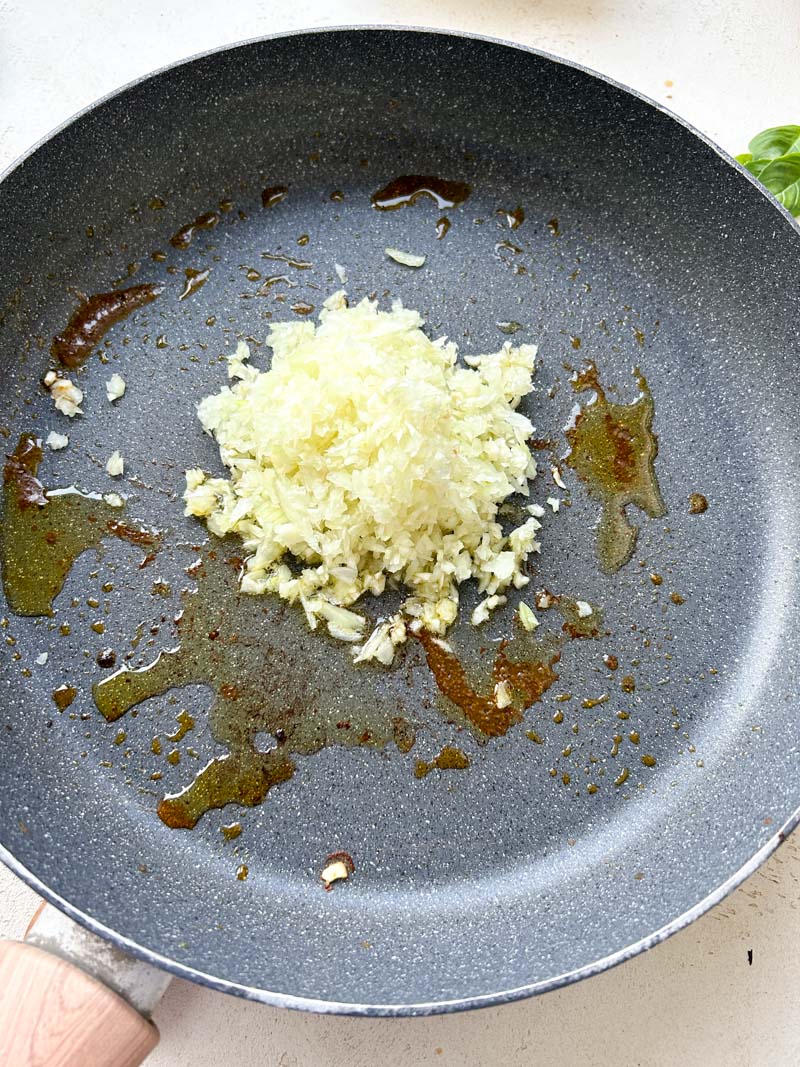 Minced garlic and onion in a frying pan.