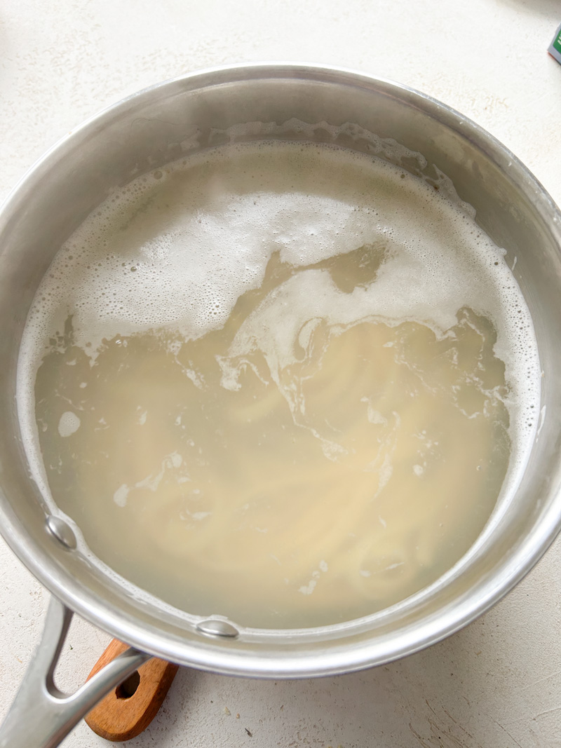 Pasta cooking in a saucepan of boiling water.