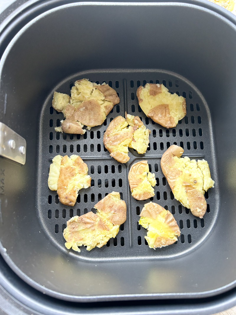 Smashed potatoes in the Air Fryer basket, before cooking.